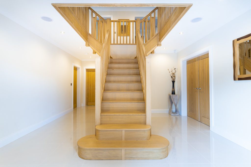 Large hallway with T-shaped oak staircase leading up to a landing
