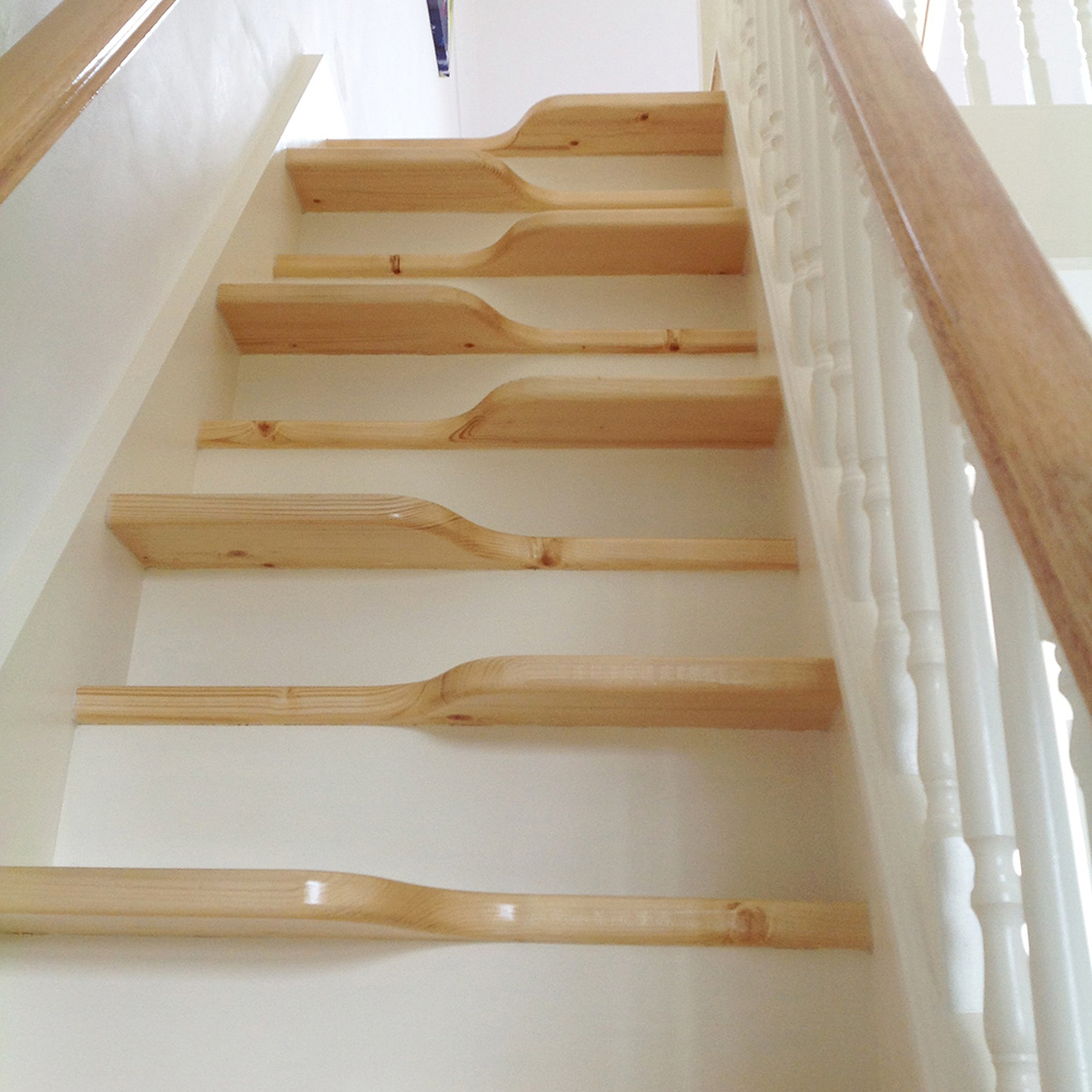 Angled from the bottom of the flight, the oak alternating 'paddle' treads are rise up the flight.