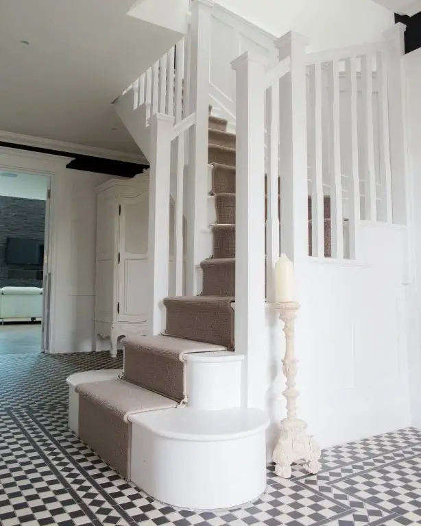 A white painted cut string staircase